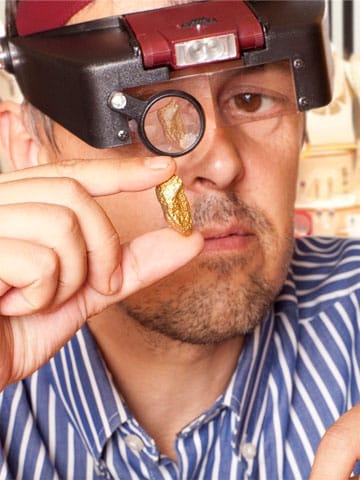 jeweler-examining-a-gold-nugget